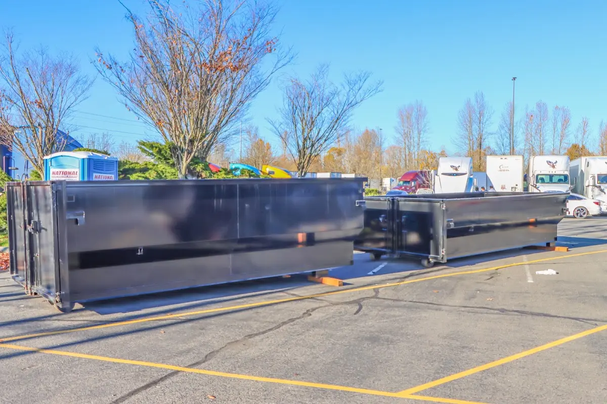 Professional dumpster rental service with roll-off container on residential driveway in Deerfield Beach